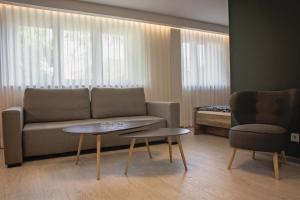 a living room with a couch and a table at Apartament Piano 3 in Racibórz