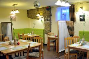 a dining room with wooden tables and chairs at Villa Dom Julii in Sanok