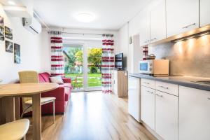 a kitchen and living room with a couch and a table at Apartment Japka in Bovec