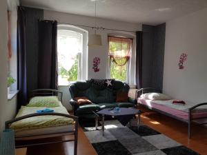 ein Wohnzimmer mit einem Sofa und einem Tisch in der Unterkunft Haus am Sachsenring in Hohenstein-Ernstthal