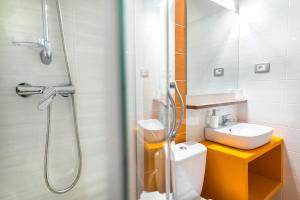 a bathroom with a shower and a toilet and a sink at Apartment Japka in Bovec +28 photos