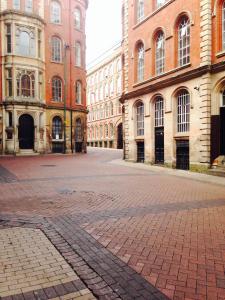 an empty street in a city with tall buildings at Versailles in Nottingham