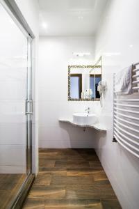 a bathroom with a sink and a mirror at Pod Ksiecia Gorka in Oleszyce