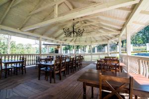 a dining room with tables and chairs on a wooden deck at Pod Ksiecia Gorka in Oleszyce