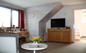 a living room with a flat screen tv on a wall at Ferienwohnung Hermann-Daur-Weg in Cuxhaven