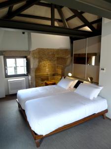 Una cama o camas en una habitación de Blanco Apartamentos Turísticos
