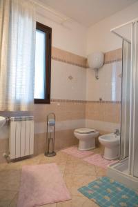 a bathroom with a toilet and a sink at Bed And Breakfast Eden Green in Alghero