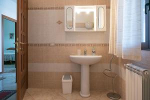 a bathroom with a sink and a mirror at Bed And Breakfast Eden Green in Alghero
