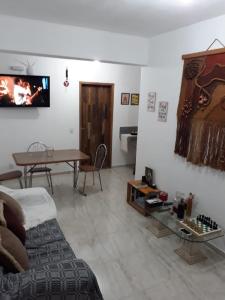 a living room with a couch and a table at Thiferer Hostel in Viçosa