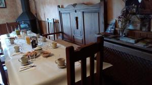 una mesa con un mantel blanco con comida. en La Posada del Arba, en El Frago