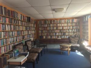 a library with rows of book shelves filled with books at Shoshone RV Park in Shoshone
