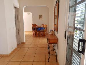 a kitchen and dining room with a table and chairs at Araceli in Famara