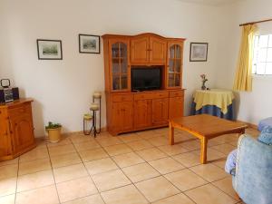 a living room with a couch and a tv at Araceli in Famara