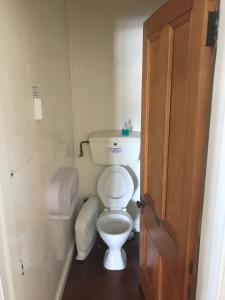 a bathroom with a toilet in a small room at The Pier Hotel in Kaikoura