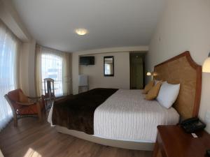 a bedroom with a large bed in a room at Sol Plaza Hotel in Puno