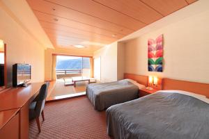 Postel nebo postele na pokoji v ubytování Akazawa Onsen Hotel