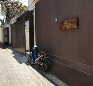 a motorcycle parked on the side of a building at Villa Anyelir in Seminyak