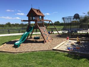a playground with a slide and a swing set at Cottages On St Andrews in Havelock North