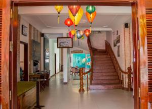 a hallway with a staircase with colorful lanterns at DK's Backpacker Hotel in Hoi An