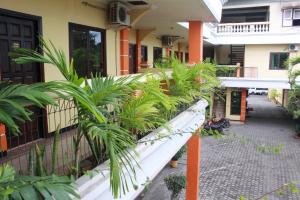 a balcony of a building with a bunch of plants at Hotel Ronggolawe in Cepu