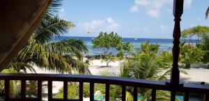 a view of the beach from the balcony of a resort at Arora Inn in Maafushi