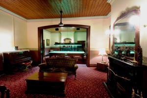 a living room filled with furniture and a fireplace at Ranelagh House in Dubbo