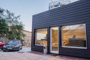 a black house with large sliding glass doors at Eagle House Inn in Vladivostok