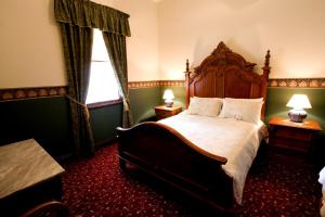 a bedroom with a bed and a dresser at Ranelagh House in Dubbo