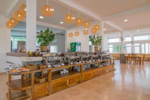 a cafeteria with a buffet line with food at Palma Resort in Phu Quoc