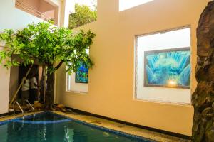 a swimming pool in a house with a tree at P A Resort in Yelagiri