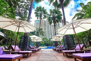a row of chairs and umbrellas at a resort at Ocean Sonic Resort Sanya in Sanya