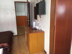 a room with a small desk with a television on it at Golden Night Hotel Cameron Highlands in Cameron Highlands +43 photos