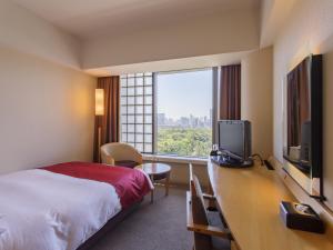a hotel room with a bed, television and a window at Hotel Grand Arc Hanzomon in Tokyo