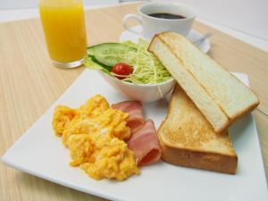 a plate of breakfast food with eggs toast and a cup of coffee at Hotel Luna Kashiba (Adult Only) in Kashiba
