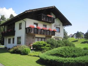 ein Gebäude mit Balkonen und roten Blumen darauf in der Unterkunft Ferienwohnungen Tillian in Hermagor