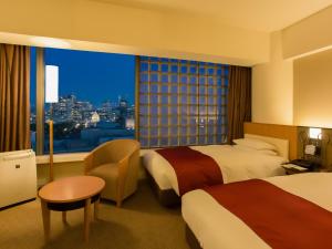 a hotel room with two beds and a large window at Hotel Grand Arc Hanzomon in Tokyo