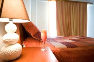 a wine glass sitting on a table in a hotel room at Hotel Grand Nefeli in Vasiliki