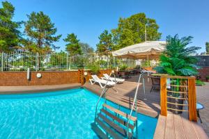 a pool with a table and chairs and an umbrella at Park Hotel in Krasnodar