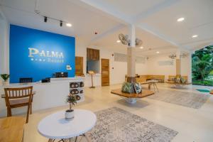 a lobby with a palaia resort sign on the wall at Palma Resort in Phú Quốc