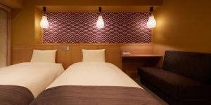 Postel nebo postele na pokoji v ubytování Sakura Sky Hotel