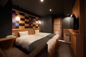Postel nebo postele na pokoji v ubytování Sakura Sky Hotel