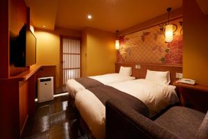Postel nebo postele na pokoji v ubytování Sakura Sky Hotel