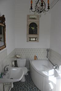 a bathroom with a tub and a toilet and a sink at La Maison de Beauport in Paimpol +24 photos