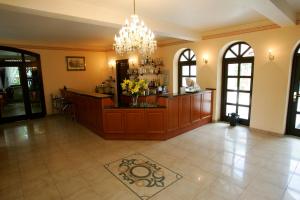 a large room with a lobby with a counter with flowers at Hotel Wenus in Kazimierz Dolny