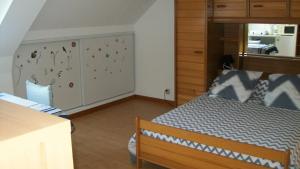 - une chambre avec un lit et un mur orné de papillons dans l'établissement Gilles Diais, à Louisfert