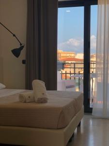 Postel nebo postele na pokoji v ubytování Albergo Milazzo Inn AiMori