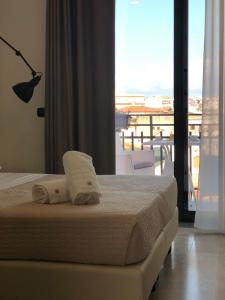 Postel nebo postele na pokoji v ubytování Albergo Milazzo Inn AiMori