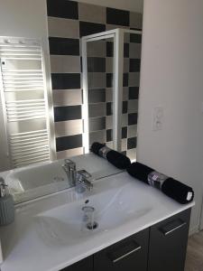 a bathroom with a white sink and a mirror at Les lumières de Sarlat in Sarlat-la-Canéda