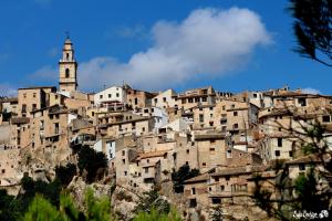a town on the side of a mountain with a clock tower at Casa Rural Casa Gimeno in Bocairent