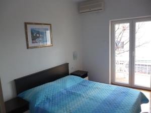 Postel nebo postele na pokoji v ubytování Apartmani Ana